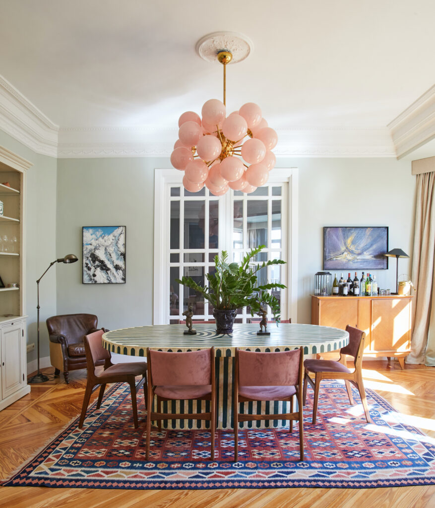 Within the walls of our Madrid apartment, the pink bubble ceiling lamp from an exquisite antique store reigns as the radiant centerpiece, casting a spell of timeless elegance and infusing every corner with its enchanting glow.