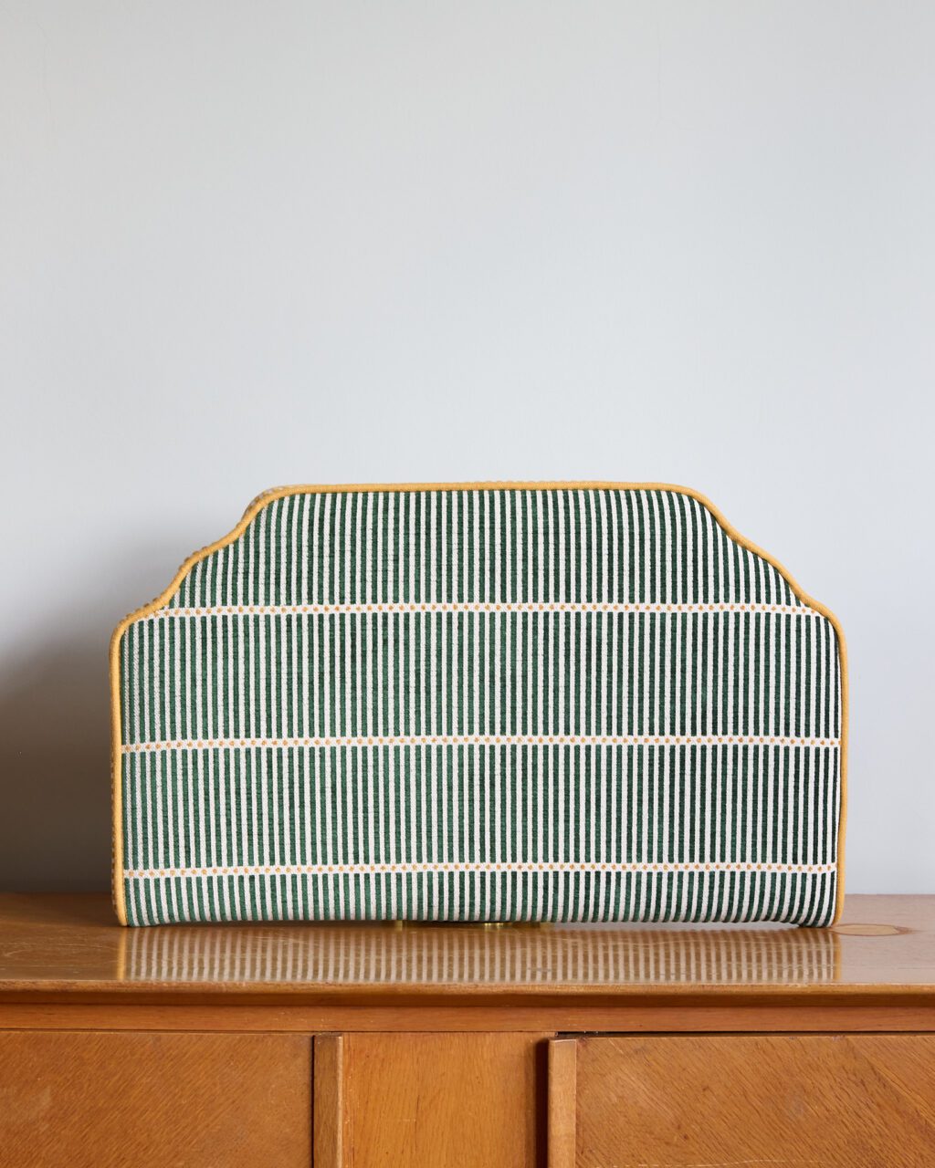 Add subtle style with this cut-corner headboard—striped sage upholstery, mustard piping, and a crisp silhouette. A versatile piece for kids' rooms, guest spaces, or refined interiors.
